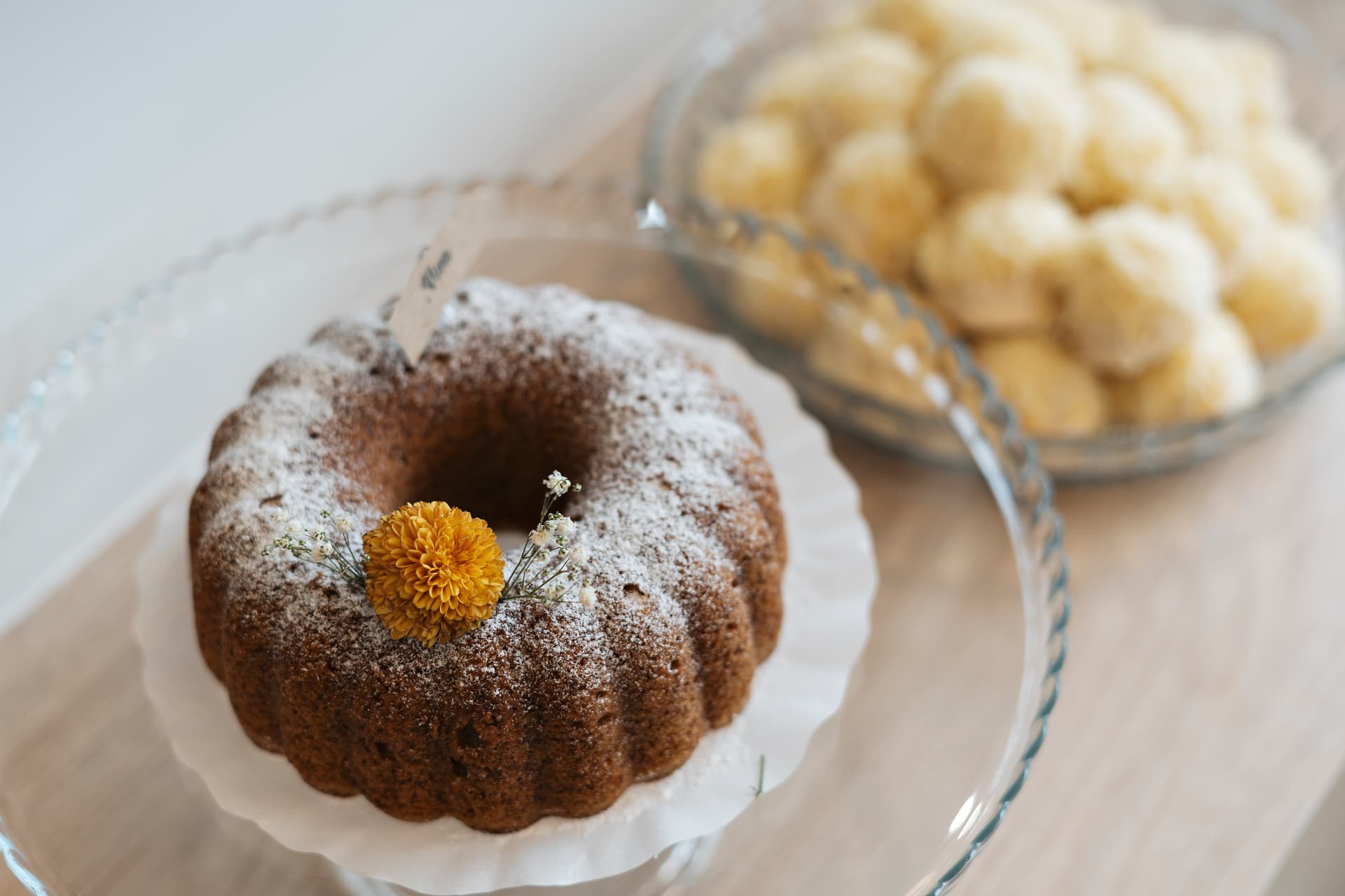 Bolo caseiro polvilhado com açúcar e decorado com flor seca